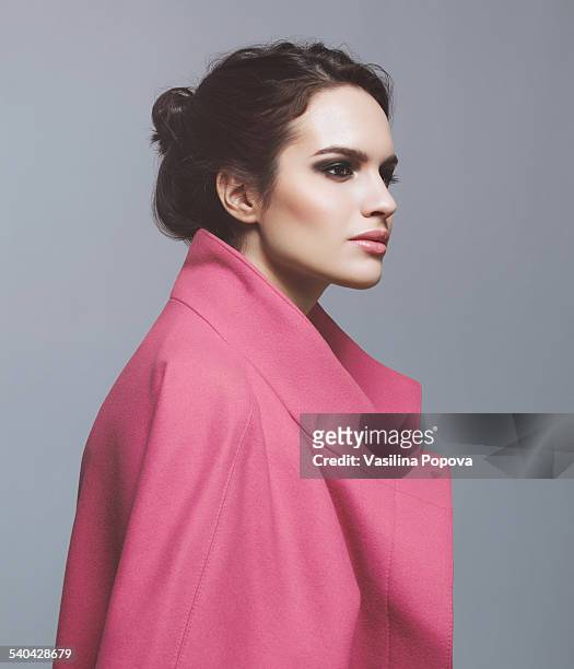woman in pink coat - fashion model stock-fotos und bilder