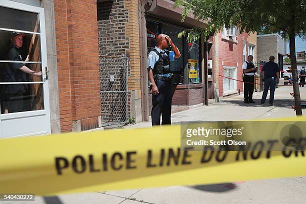 Police investigate a crime scene after two people were shot on the near Westside on June 15, 2016 in Chicago, Illinois. One witness said two area...