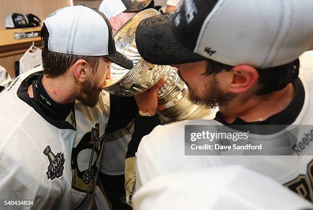 Goaltender Matt Murray of the Pittsburgh Penguins drinks from the Stanley Cup near Sidney Crosby in the locker room after winning Game 6 of the 2016...