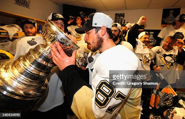 Sidney Crosby of the Pittsburgh Penguins drinks from the Stanley Cup in the locker room after winning Game 6 of the 2016 NHL Stanley Cup Final over...