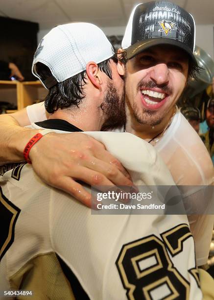 Sidney Crosby and teammate Evgeni Malkin of the Pittsburgh Penguins celebrate with the Stanley Cup in the locker room after winning Game 6 of the...