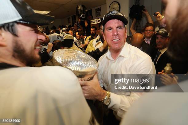 Head coach Mike Sullivan of the Pittsburgh Penguins celebrates with the Stanley Cup in the locker room after the Penguins won Game 6 of the 2016 NHL...