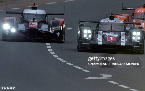 Germanys Timo Bernhard drives his Porsche 919 Hybrid n1 ahead of Brazil's Lucas Di Grassi Audi R18 Hybrid n8, during the free practice session of the...