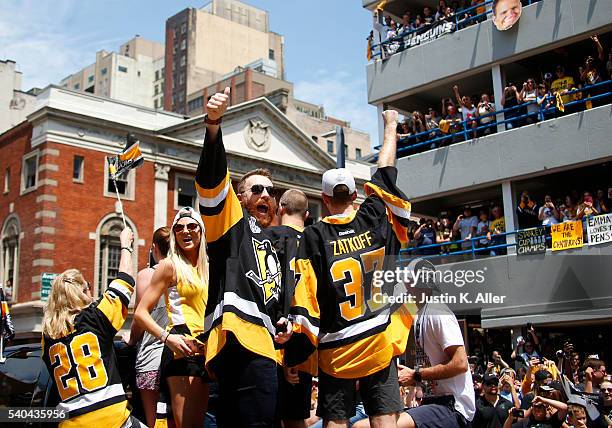 Ian Cole and Jeff Zatkoff of the Pittsburgh Penguins celebrate during the Victory Parade and Rally on June 15, 2016 in Pittsburgh, Pennsylvania. The...