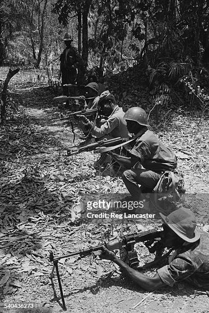 Rebel army on patrol with some of the issued range of Russian weapons including machine guns, assault rifles, and a bazooka during the Portuguese...