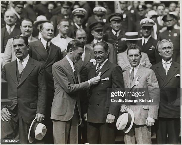 Great Reception Given to Gallant French Flyers. New York. Photo shows: Mayor Walker of New York pinning the city's medal on Coste. His comrade,...