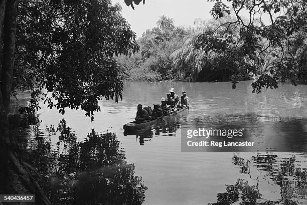 Rebel army on patrol crossing a river during the Portuguese Colonial War, Guinea-Bissau, West Africa, 1972.
