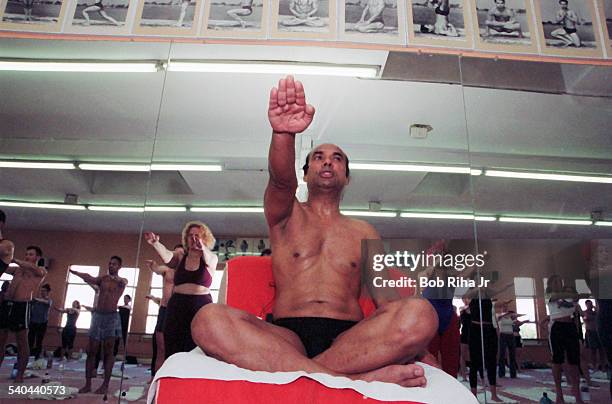 Low-angle view of Indian Yoga guru Bikram Choudhury as he instructs his yoga class in heated room, Beverly Hills, California, February 2, 2000.