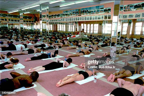 View of students during a yoga class in heated room, Beverly Hills, California, February 2, 2000. Indian Yoga guru Bikram Choudhury instructs the...