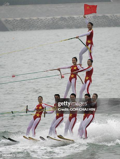 Chinese acrobatic water skiing team show off their skills, after recovering from an earlier tumble, during a performance at the opening ceremony of...