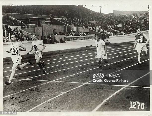 The finish of the sixth heat of the 200-meter dash. The winner of this heat is Jackson Scholz of the US. Second came Adams of Canada . Note the...