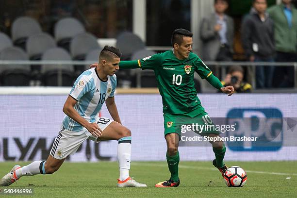 Erik Lamela of Argentina challenges Jhasmani Campos of Bolivia during a group D match between Argentina and Bolivia at CenturyLink Field as part of...