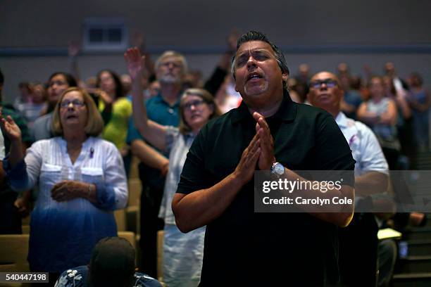 Josheph Lausell prays during a service at the First Baptist Church of Orlando during a special prayer service for the attack on Pulse nightclub.