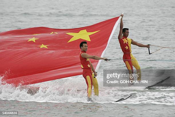 Chinese water skiers carry the national flag during a performance at the opening ceremony of the 2005 International Europe Class Yacht World...
