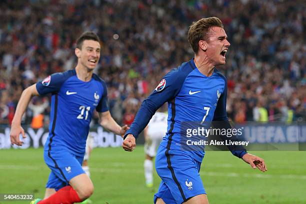 Antoine Griezmann of France celebrates with Laurent Koscielny scoring his sides first goal during the UEFA EURO 2016 Group A match between France and...