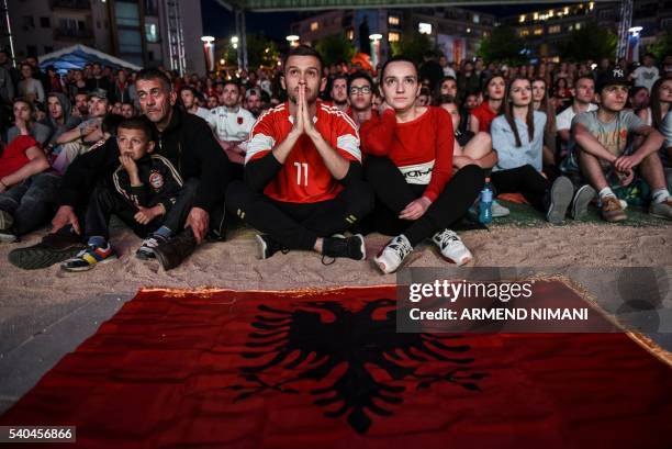 Albania's supporters react as they watch on a giant screen the Euro 2016 football match between France and Albania at the fan zone on the Mother...