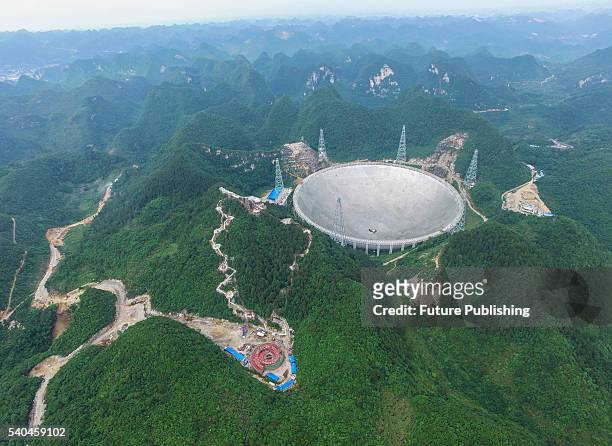 View of the Five-hundred-meter Aperture Spherical radio Telescope near its completion on June 13, 2016 in the remote Pingtang county, China. The...