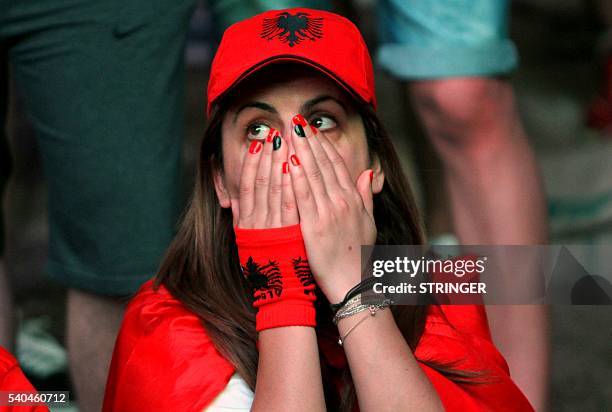 Albanias supporters react as they watch the Euro 2016 football match between France and Albania at the fan zone on Tiranas main boulevard on June 15,...