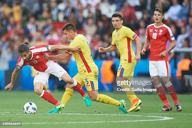 Ricardo Rodriguez of Switzerland and Ovidiu Hoban of Romania during the UEFA Euro 2016 group A match between Romania and Switzerland at the Parc des...
