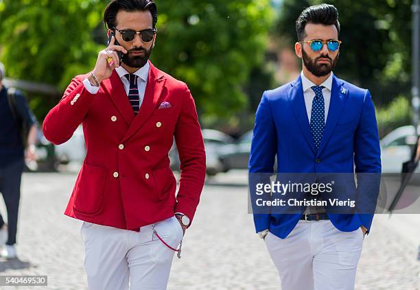 Guests wearing a red and blue blazer and white pants during Pitti Uomo 90 on June 15 in Florence, Italy