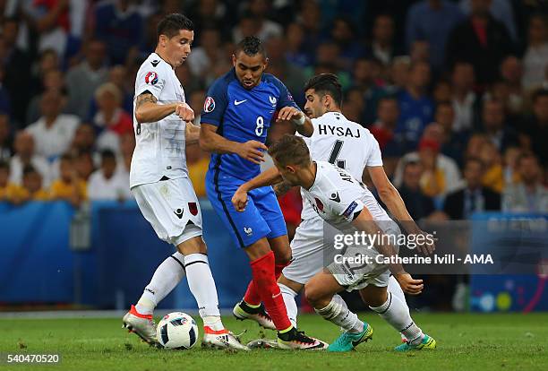 Odise Roshi, Elseid Hysaj and Amir Abrashi of Albania tackle Dimitri Payet of France during the UEFA EURO 2016 Group A match between France and...