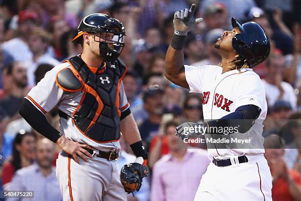 Hanley Ramirez of the Boston Red Sox celebrates in front of Matt Wieters of the Baltimore Orioles after hitting a three run homer during the third...