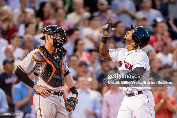 Hanley Ramirez of the Boston Red Sox reacts after hitting a three run home run as Matt Wieters of the Baltimore Orioles looks on during the third...