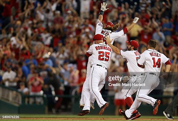 Jayson Werth of the Washington Nationals celebrates with teammates Clint Robinson, Tanner Roark, and Chris Heisey after hitting a walk-off single RBI...