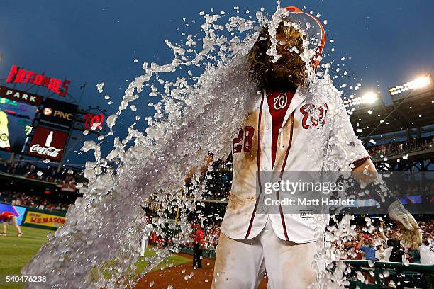 Jayson Werth of the Washington Nationals is doused with a bucket of Gatorade by teammate Wilson Ramos after hitting a walk-off single RBI in the...