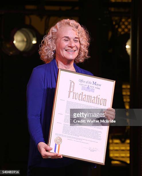 Musician Carole King receives a mayoral proclamation during the curtain call of the 1000th performance of 'Beautiful - The Carole King Musical' at...