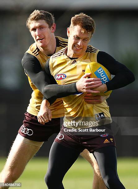 Sam Mitchell of the Hawks is tackled by Ben McEvoy of the Hawks during a Hawthorn Hawks AFL training session at Waverley Park on June 16, 2016 in...