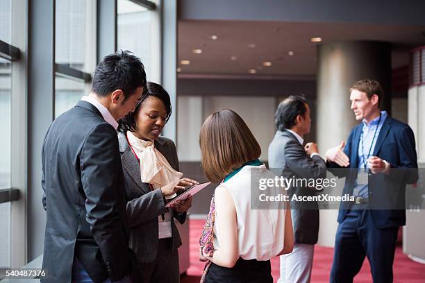 business team consulting in the foyer at a conference - convention center outside stock pictures, royalty-free photos & images