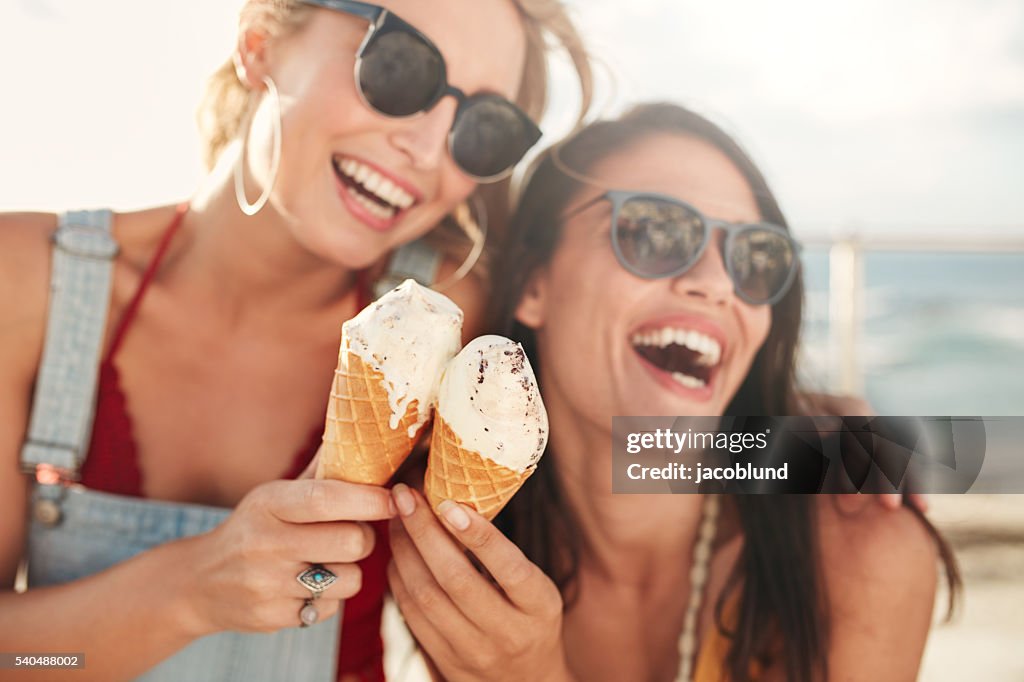 Female friends having fun and eating ice cream