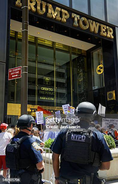 nypd counter-terrorism officers watch protesters, trump tower, midtown manhattan, nyc - street style new york city march 2016 stock pictures, royalty-free photos & images