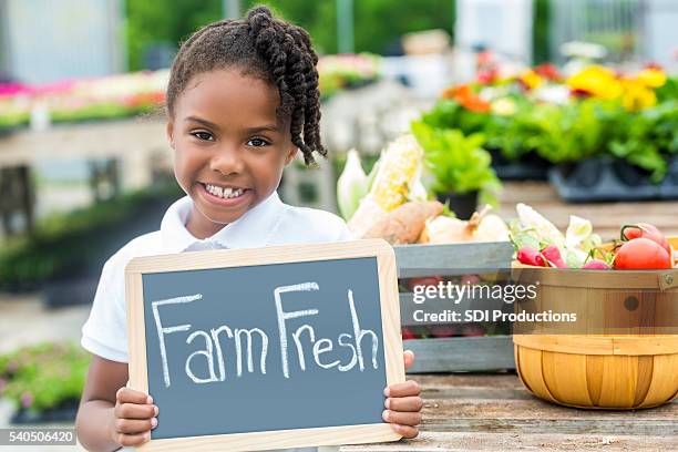 girl with farm fresh sign at farmers market - green chalkboard stock pictures, royalty-free photos & images