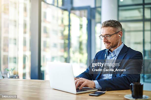 he's all about productivity and profitability - business headphones stockfoto's en -beelden