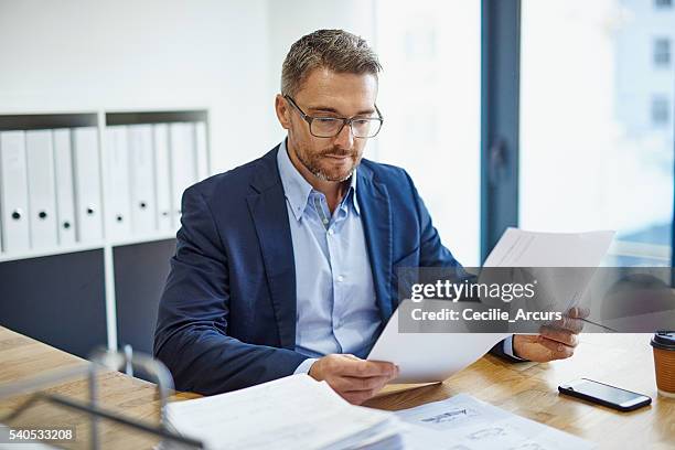 blazing through his paperwork - decisions stockfoto's en -beelden