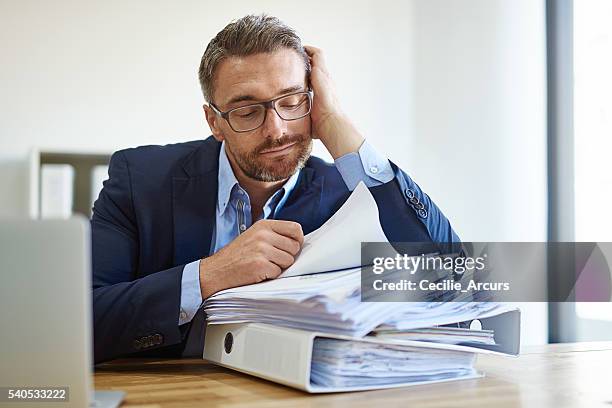 fighting a losing battle against paperwork - bored worker stock pictures, royalty-free photos & images