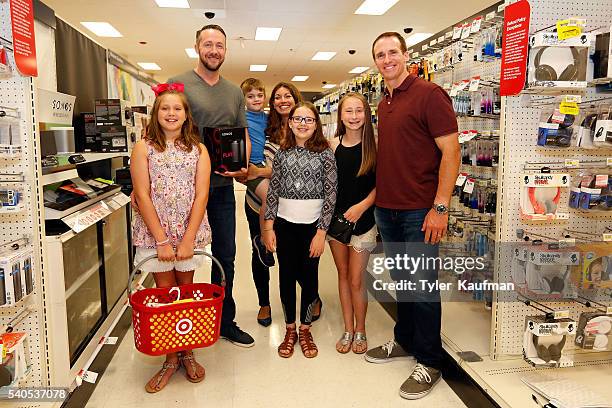Drew Brees, Quarterback of the New Orleans Saints, surprises Target guests and helps them shop for last minute father's day gifts at Target on June...