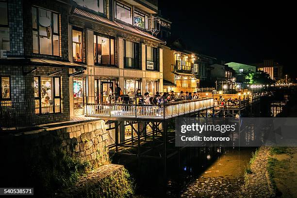 riverbed style cuisine along kamo river at night - kyoto stock pictures, royalty-free photos & images