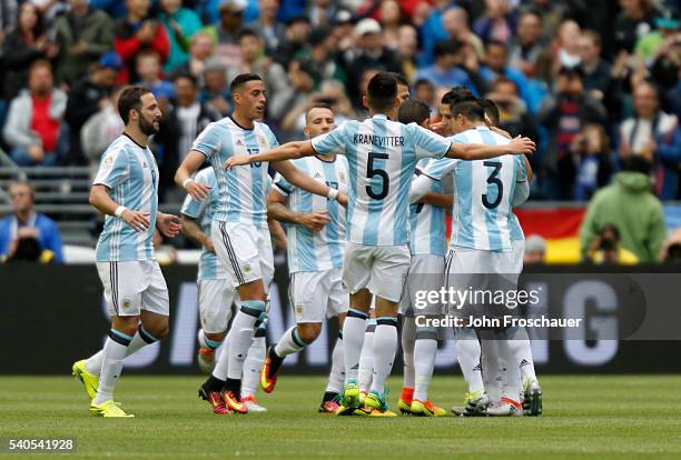 Victor Cuesta of Argentina celebrates with teammates after scoring the third goal of his team during a group D match between Argentina and Bolivia at...