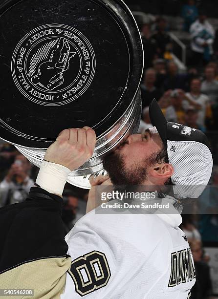 Brian Dumoulin of the Pittsburgh Penguins celebrates with the Stanley Cup after the Penguins won Game 6 of the 2016 NHL Stanley Cup Final over the...