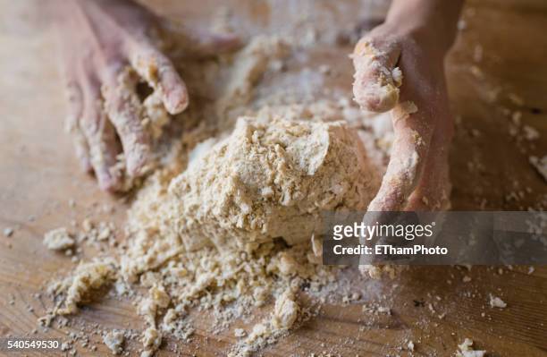 hands kneading homemade dough - teig kneten stock-fotos und bilder