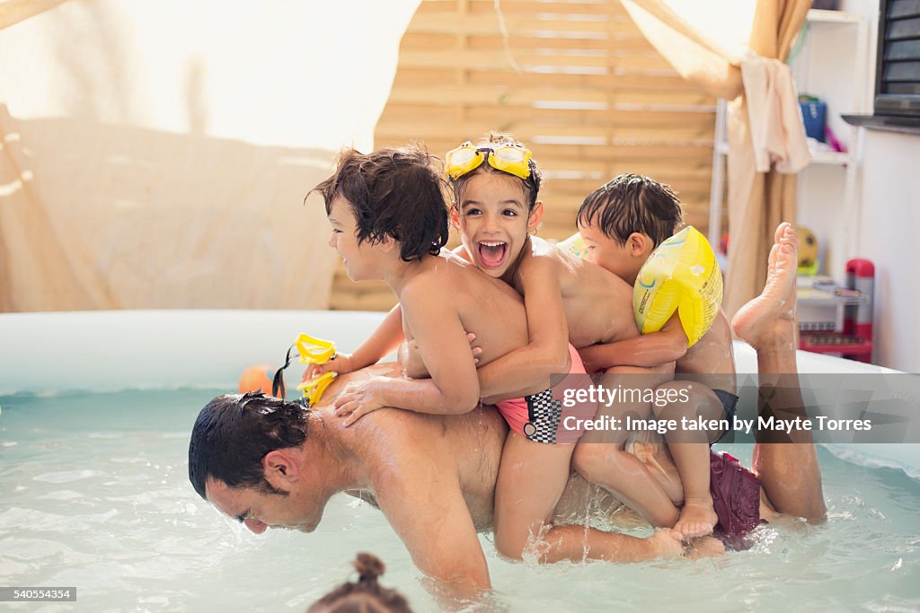 Children playing with dad