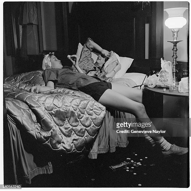 Two teenagers relax on a bed at the end of the day. They were part of a photo essay published in McCall's Magazine depicting the day in the life of...