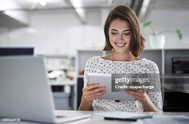 make technology work for you - woman smiling using digital tablet stock pictures, royalty-free photos & images