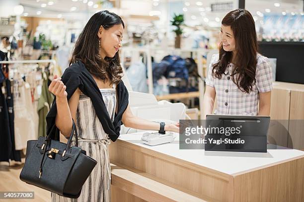 contactless payment at supermarket - smartwatch pay stock pictures, royalty-free photos & images