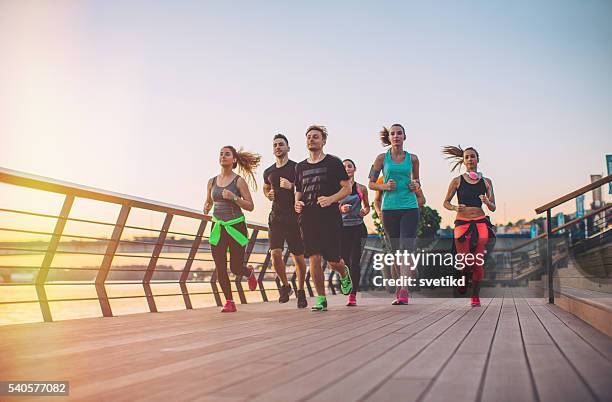 it's always better exercising in a group - marathon stock pictures, royalty-free photos & images