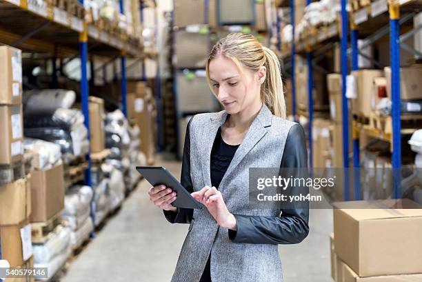 concentrated business woman searching on tablet - internal communication stock pictures, royalty-free photos & images