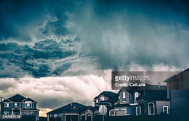 dramatic storm clouds over residential neighborhood. colorado, usa - storm season stock pictures, royalty-free photos & images